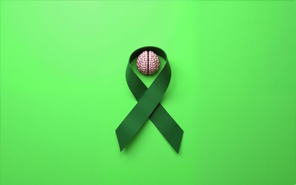 World mental health day concept. Green awareness ribbon with brain symbol on a green background. High quality