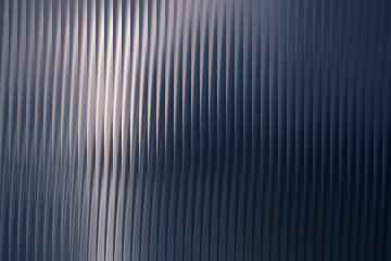 A textured metallic surface displays subtle vertical reflections with a gradient from dark blue to a lighter, almost silver hue, creating an abstract background.