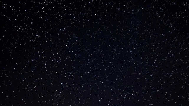 A timelapse of moonlit bokeh and star particles in the night sky.