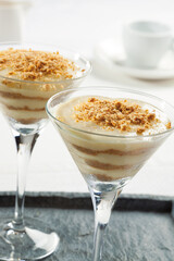Custard dessert with crumbled biscuits served in glasses. Portuguese dessert.
