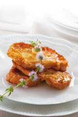French toast dipped in honey and served on an elegant plate.