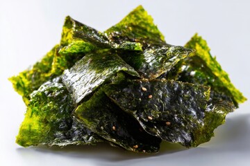 Crispy seaweed snacks with sesame seeds on white background