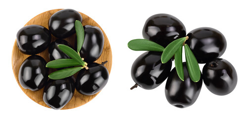 Black olives with leaves in wooden bowl isolated on a white background with full depth of field. Top view. Flat lay