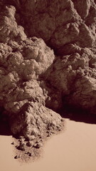 A massive rock formation stands prominently in the vast desert landscape, surrounded by endless stretches of sand.