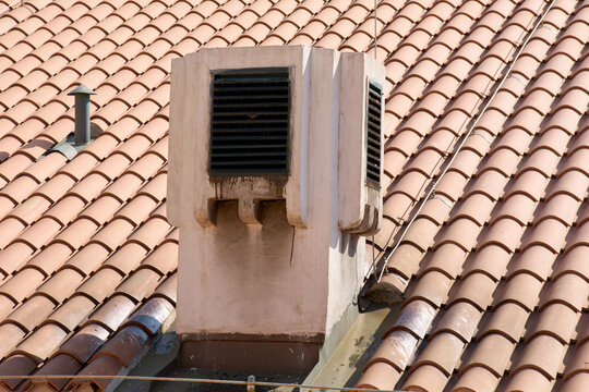 Traditional Mediterranean architecture. A chimney vent on an iconic red roof in Dubrovnik. Vertical format for social media stories.
