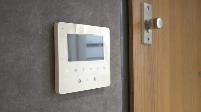 Modern intercom system with a screen and door handle in a contemporary interior