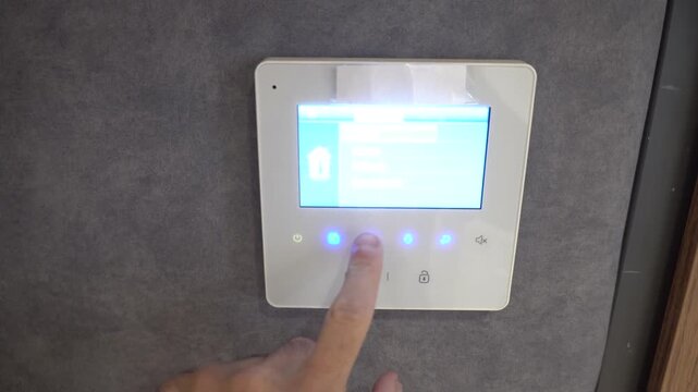Modern intercom system with a finger pressing a button on the screen