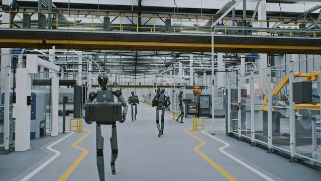 Humanoid Robots Working Automation and AI in Modern Futuristic Factory. Android Robots Moving Equipment in Clean, Automated Industrial Environments. Concept of Future of Work and AI Driven Automation.
