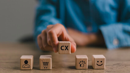 Customer Experience Strategy Concept. Wooden blocks with various stage icons of customer experience, including shopping, feedback and satisfaction. Marketing strategies and personalized engagement. 