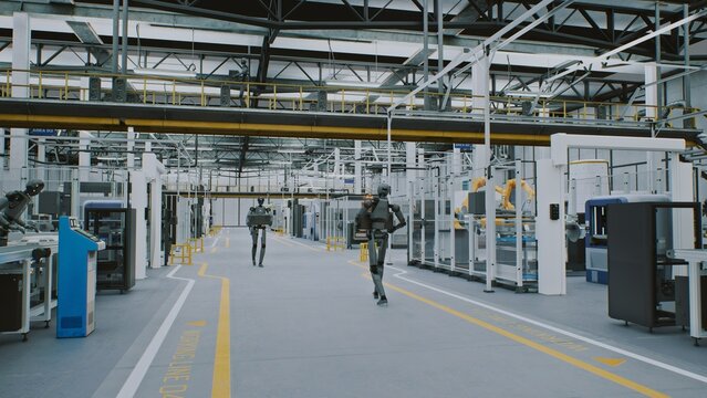 Humanoid Robots Working Automation and AI in Modern Futuristic Factory. Android Robots Moving Equipment in Clean, Automated Industrial Environments. Concept of Future of Work and AI Driven Automation.