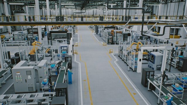 Automated Factory Floor With Robots. Modern Automated Factory Floor Shows Multiple Robotic Arms and Conveyor Belts Working Synchronously. Concept of Industry 4.0, Advanced Manufacturing. High Angle.