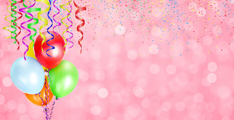 Colorful balloons on pink blurred background with confetti and streamers for party time. Empty...