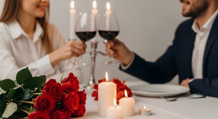 Romantic couple toasting with wine at candlelit dinner