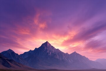 Obraz premium Majestic Mountains under a Fiery Sky: Towering mountain peaks pierce a dramatic sky ablaze with vibrant hues of purple and orange, painting a breathtaking vista.