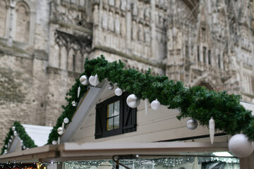 Christmas market with wooden house shops and cathedral in the center of Rouen