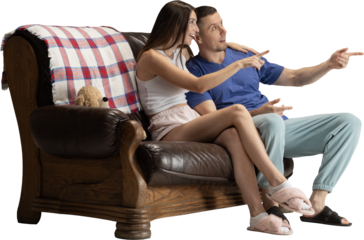 Happy couple sitting on sofa and pointing forward with excited emotion on transparent background. Concept of home lifestyle, relationship visuals, entertainment scenes and cozy domestic moments.