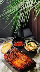 Mouthwatering barbecue ribs served with sides at a cozy restaurant