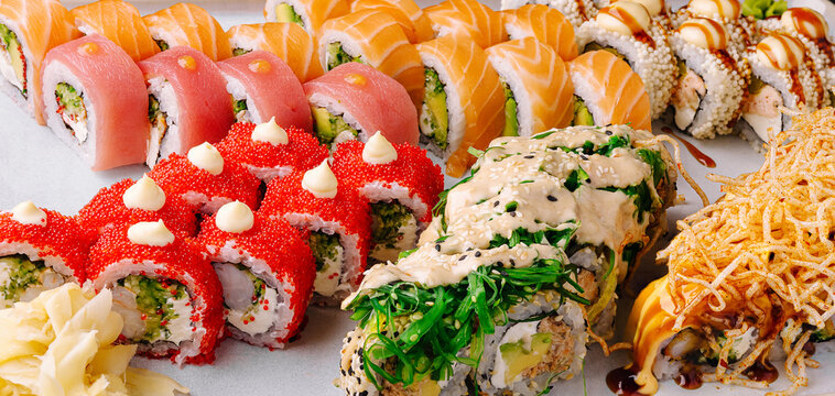 Exploring a colorful sushi platter featuring various rolls and garnishes