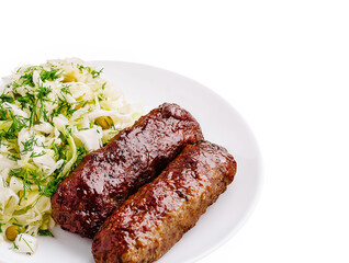 Juicy grilled meat sausages served with fresh cabbage salad