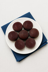 Dark Sweet Dessert Balls Arranged on a White Plate