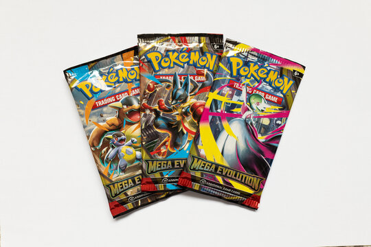Bradford, UK - Nov 19 2025 : Pok&eacute;mon Mega Evolution booster packs with Mega Kangaskhan, Lucario, and Gardevoir shown on the vibrant and shiny packets.