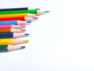 Colored pencils placed on a white background