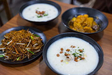 Cantonese century egg pork congee served with fried noodles