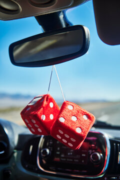 red fuzzy dice hanging off the rear view mirror 