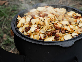 man is frying potatoes on the grill
