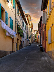 Medieval narrow street in Siena, Tuscany, Italy. Architecture and landmark of Siena. Cozy cityscape of Siena
