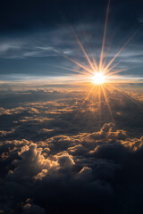 Golden-hour sunrise above sculpted atmospheric cloud layers, warm inner glow contrasting with cool blue shadows, intense central starburst flare