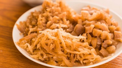 Close up of a bowl filled with shredded and diced dried persimmons