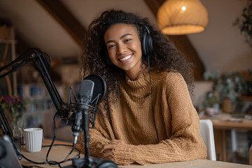 Podcast Host at Work: An enthusiastic host sits at a studio desk, ready to engage her audience, wearing headphones and speaking into a microphone.