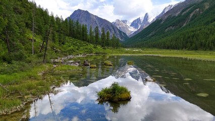 Drone flight over a mountain lake - Shavlinskoye blue lake in Altai