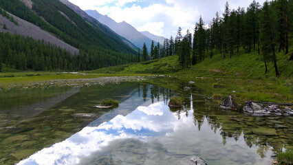 Drone flight over a mountain lake - Shavlinskoye blue lake in Altai