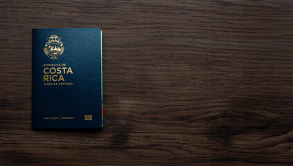 Blue biometric passport of Costa Rica placed on a dark wooden background, symbolizing travel, identity, and international mobility.