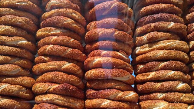 Close up of Traditional simit rings stacked behind glass in a mobile street vendor cart
