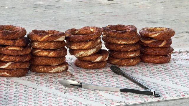 Freshly baked simit bagels stacked at a street food stall in Kadikoy