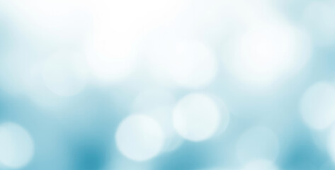 Obraz premium Abstract light blue and white background with soft circular bokeh effects that create a calm atmospheric glow, forming a smooth dreamy visual texture across the entire frame