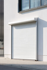 Fototapeta premium Closed industrial white roller shutter door of modern warehouse exterior.