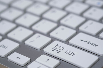 Close-up of a computer keyboard featuring a shopping cart buy key symbolizing e-commerce, online shopping, digital payment, and modern retail technology for business and marketing concepts.