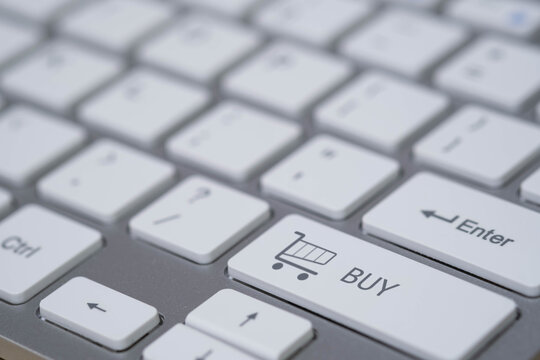 Close-up of a computer keyboard featuring a shopping cart buy key symbolizing e-commerce, online shopping, digital payment, and modern retail technology for business and marketing concepts. - Powered by Adobe
