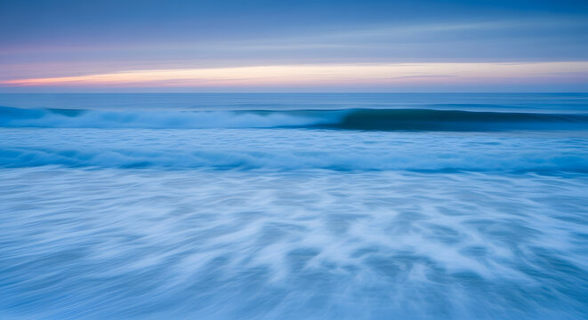 Ethereal motion blur of ocean waves at twilight, a serene and tranquil coastal scene with a soft glowing horizon - Powered by Adobe