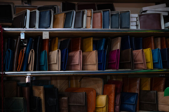 Colorful Vibrant leather handmade Moroccan bags, goods for sale in traditional local souk, story heritage and authentic oriental craftsmanship, artisanal culture Morocco