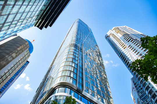 High rise office towers, glass Contemporary skyscrapers rise against clear blue sky in Frankfurt, Germany, low angle view, urban skyline, Upward view business district, European city