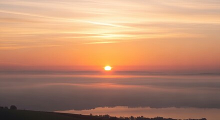 Obraz premium Sunrise above foggy landscape in warm golden lighting for travel brochure
