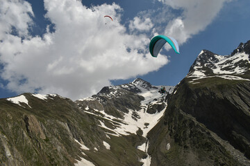 Tourists paragliding 3 pm 6 june 2025 at Leh Ladakh with view of Himalayan mountain range.