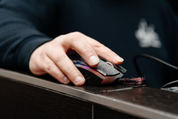 man hand on computer mouse, close-up view, working with notebook, dj or it-worker