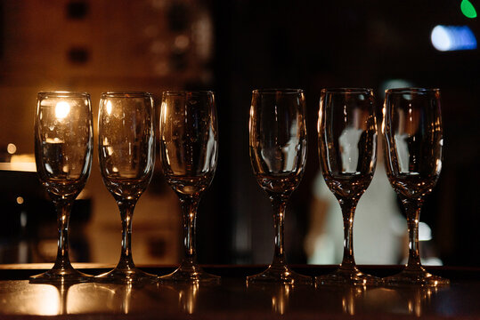 row of empty glasses for wine or champagne on bar counter