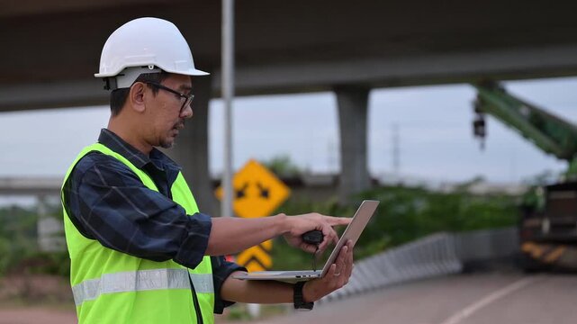 Construction Engineer's Analytical Gaze: A dedicated construction engineer, hard hat firmly in place, is meticulously focused as they navigate the complexities of a project using a laptop.